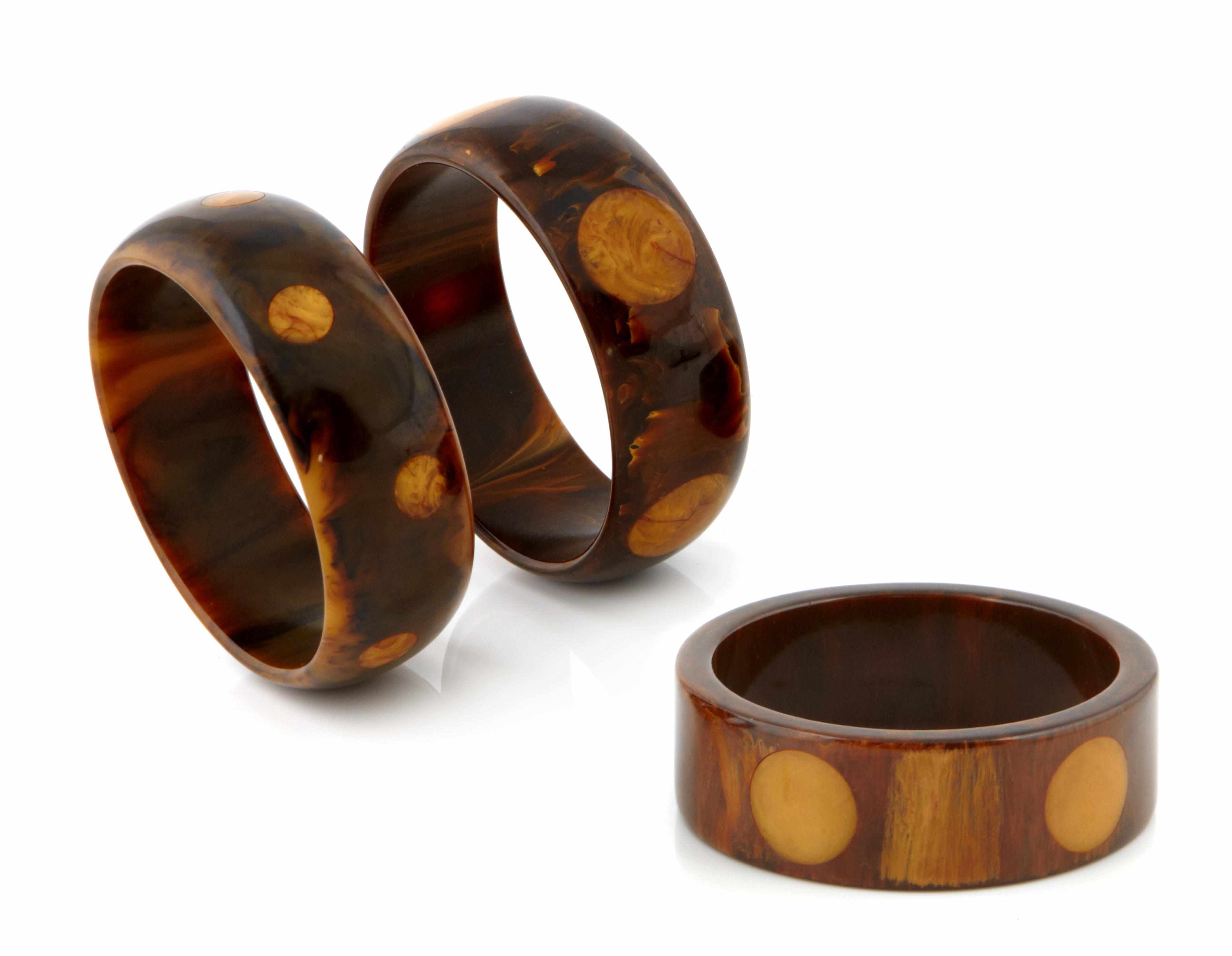 Appraisal: Three brown and butterscotch Bakelite ''dot'' bangle bracelets each diameter