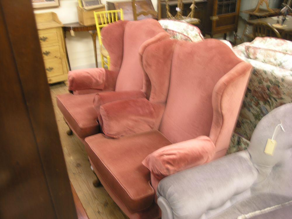 Appraisal: A pair of wing armchairs uholstered in a plum dralon