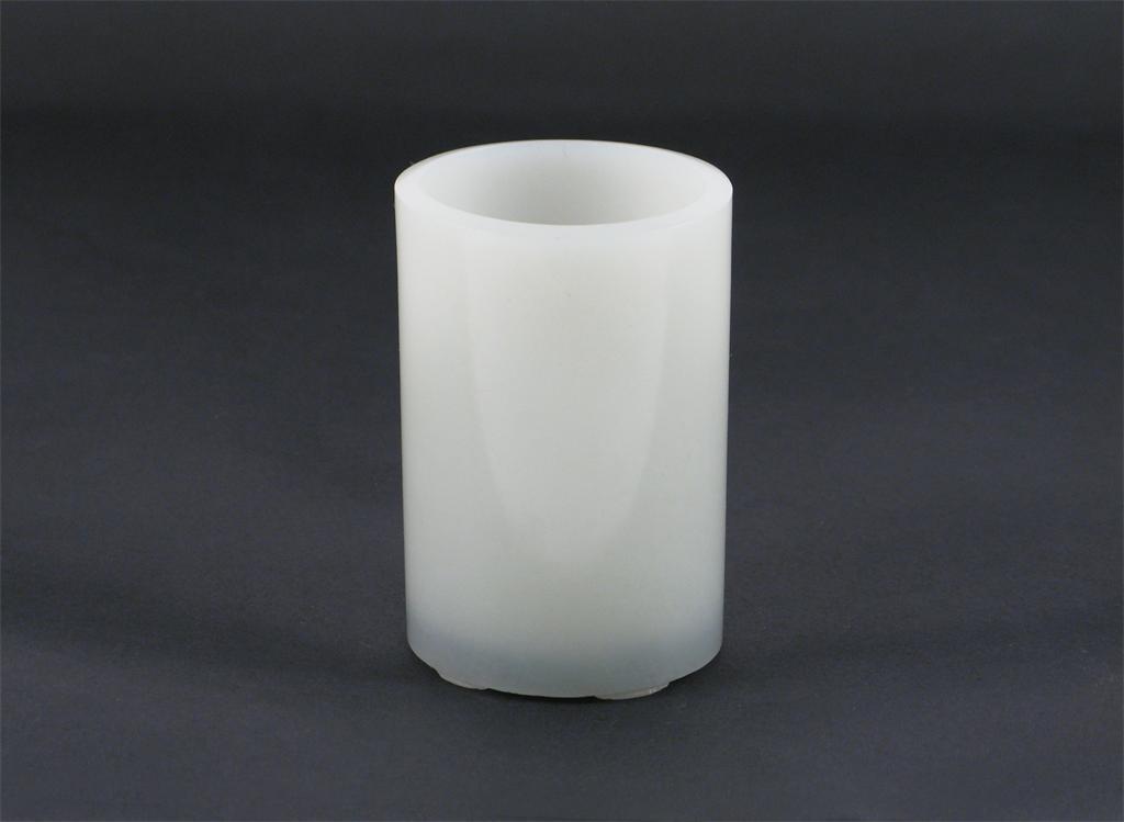 Appraisal: A Chinese pale celadon or white jade small cylindrical brushpot