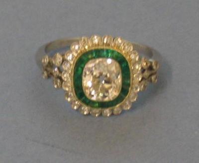 Appraisal: AN EMERALD AND DIAMOND RING comprising cushion cut diamond set