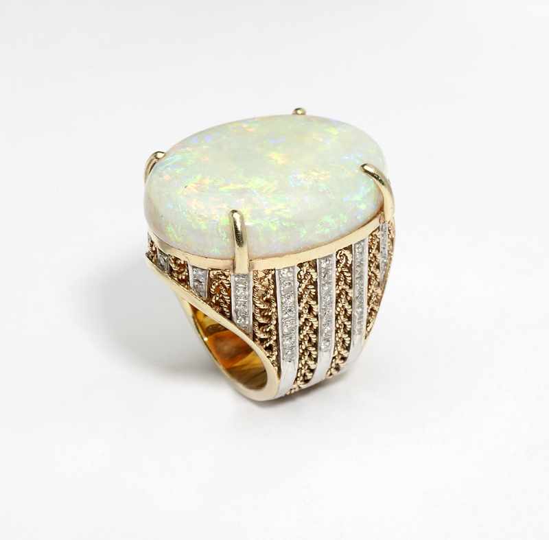 Appraisal: K bi-colored gold ring set with one large opal cabochon