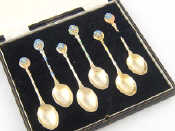 Appraisal: A boxed set of six coffee spoons with enamelled flowerheads