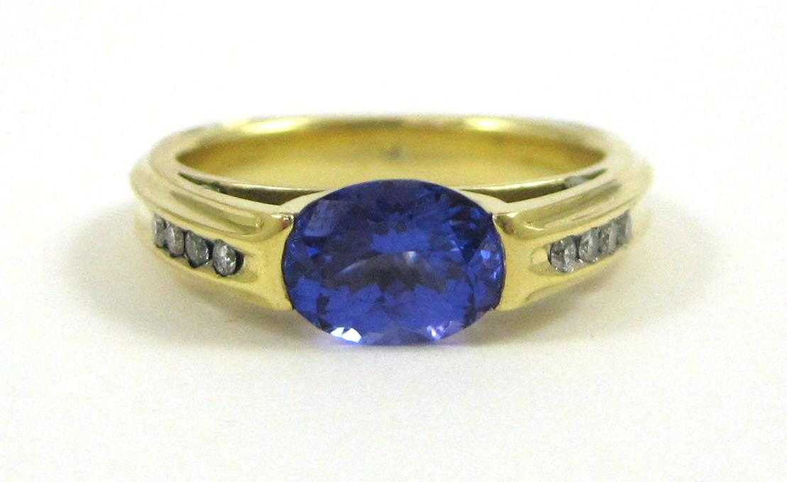 Appraisal: TANZANITE DIAMOND AND EIGHTEEN KARAT GOLD RING with round-cut diamonds