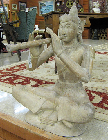 Appraisal: FIGURAL THAI WOOD SCULPTURE the seated male figure playing a