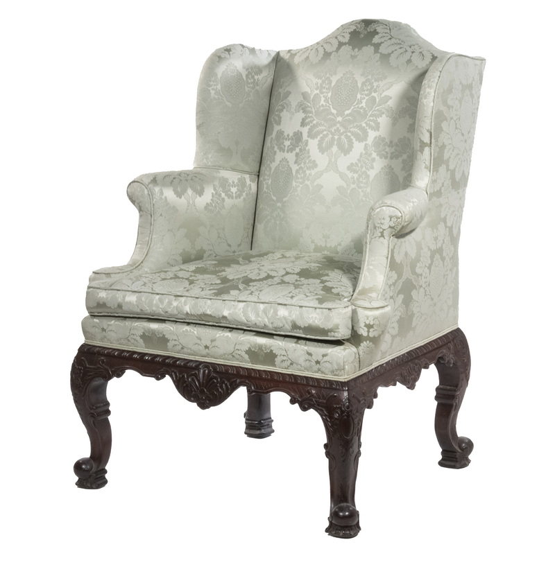 Appraisal: CONTINENTAL GENTLEMAN'S WINGCHAIR Ornately Carved Mahogany Frame camel back with