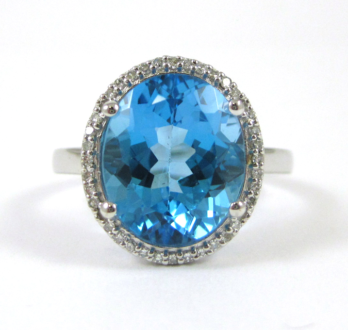 Appraisal: BLUE TOPAZ AND FOURTEEN KARAT WHITE GOLD RING with round-cut