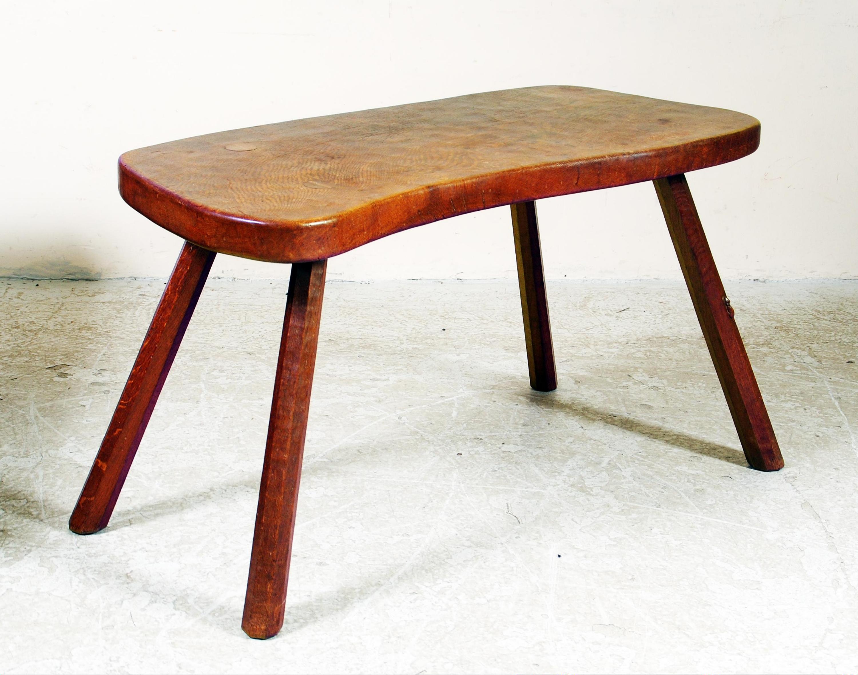 Appraisal: AN ADZED OAK TABLE by Robert Mouseman Thompson of irregular