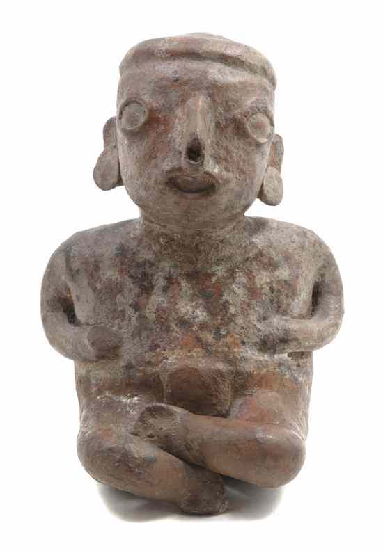 Appraisal: A Nayarit Seated Terracotta Figure retaining partial polychrome decoration Height