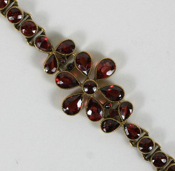 Appraisal: Gold K bracelet with approx ctw bezel set garnets arranged