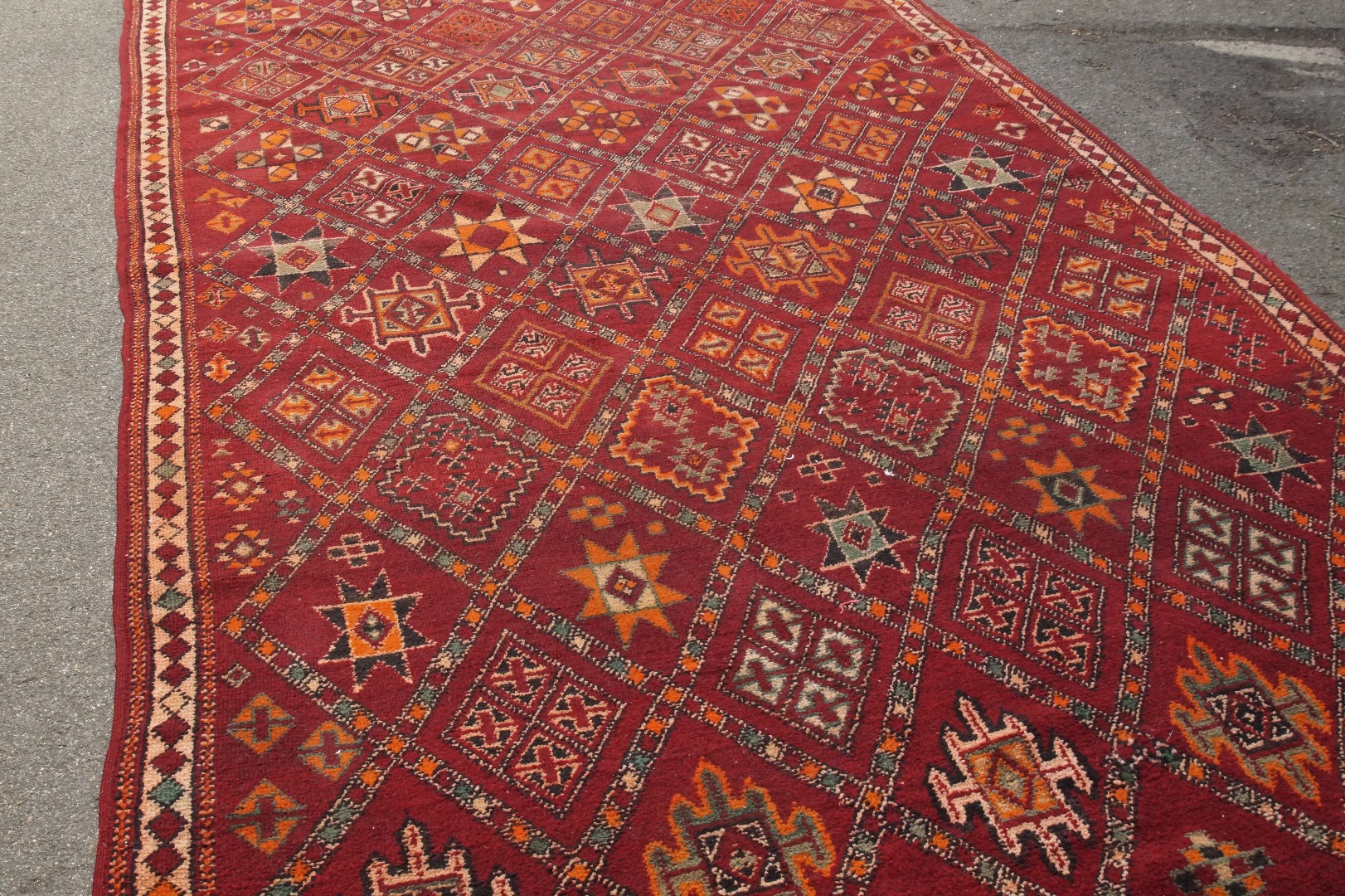 Appraisal: A Middle Eastern large knotted carpet on red ground cm