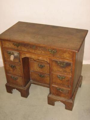 Appraisal: A GEORGE II WALNUT AND OAK KNEEHOLE DESK with oak