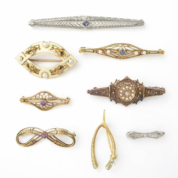 Appraisal: A collection of twenty-one enamel gem and gold brooches