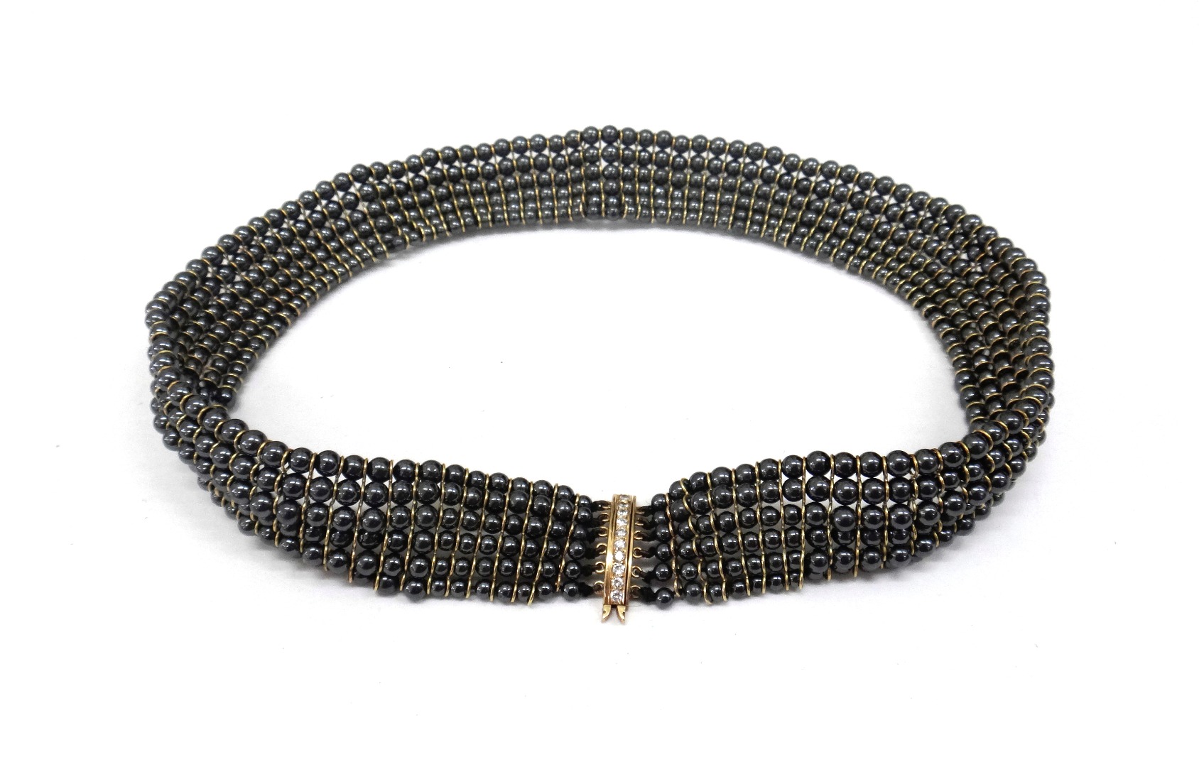 Appraisal: A six row hematite bead necklace with gold wire spaces