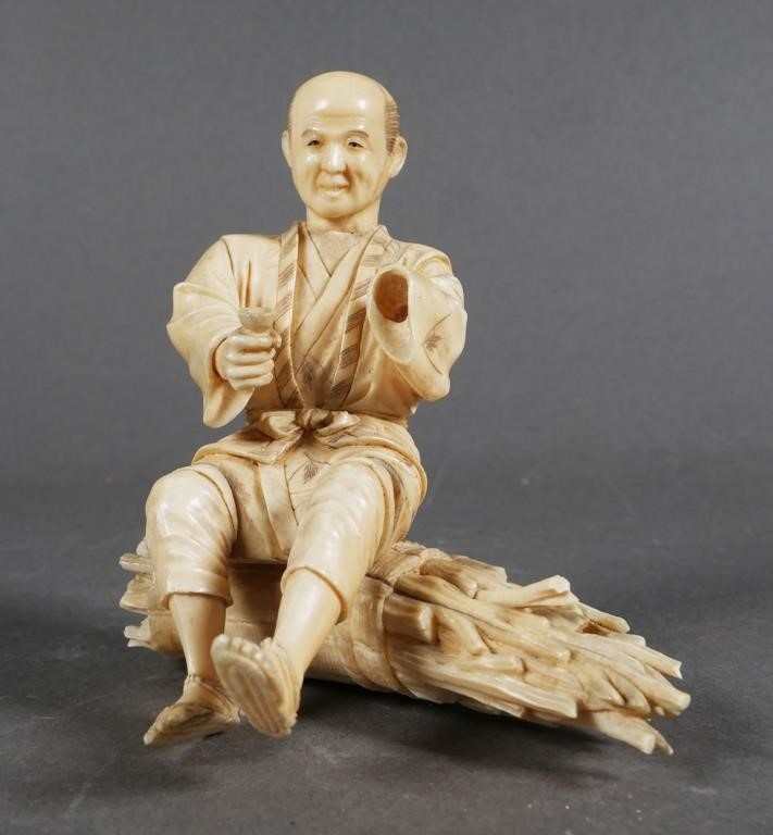 Appraisal: Old ivory carving of man sitting on a billet of