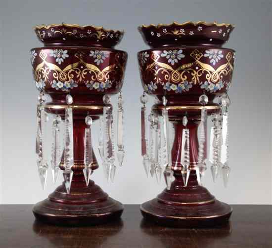 Appraisal: A pair of enamelled and gilded ruby glass table lustres