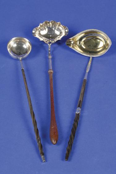 Appraisal: A GEORGE II PUNCH LADLE with a turned wooden handle