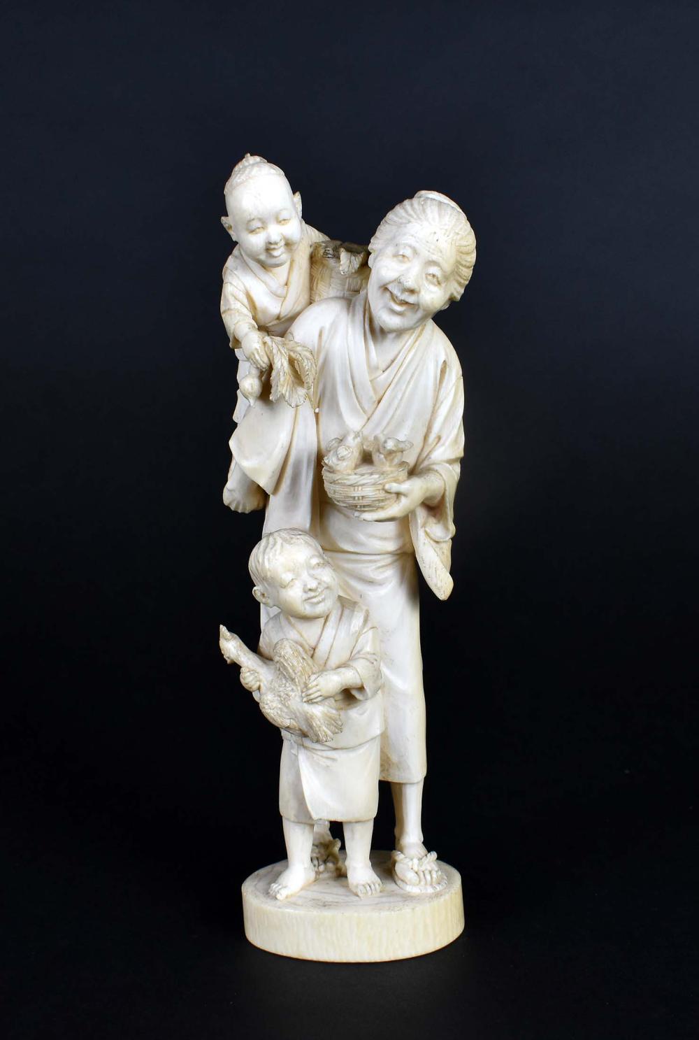 Appraisal: JAPANESE OKIMONO OF AN OLD WOMAN WITH CHILDRENMeiji Period She