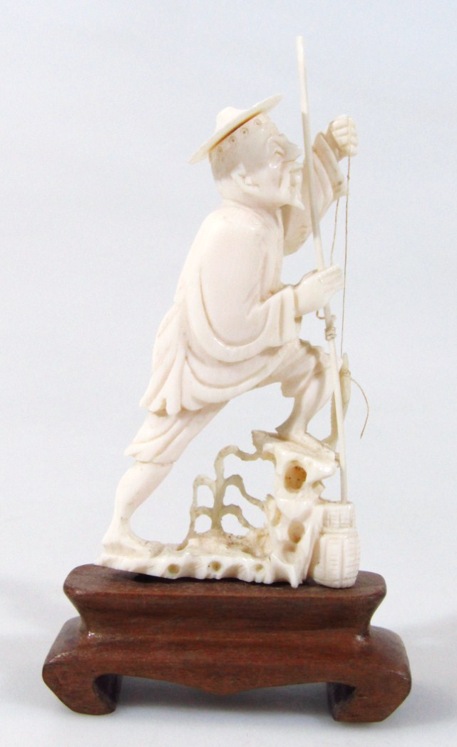 Appraisal: An early thC Chinese ivory figure of a fisherman with