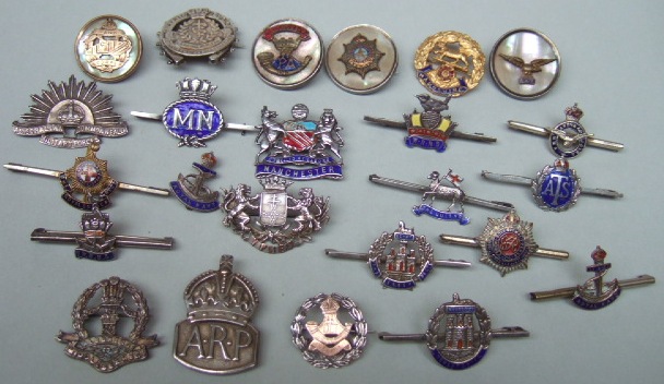 Appraisal: A collection of twenty four mostly military sweetheart brooches and