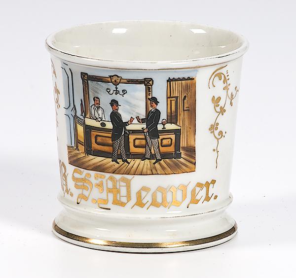 Appraisal: SHAVING MUG Porcelain mug with gilding and painting of men