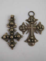 Appraisal: Two th century white metal tests silver crosses probably Middle