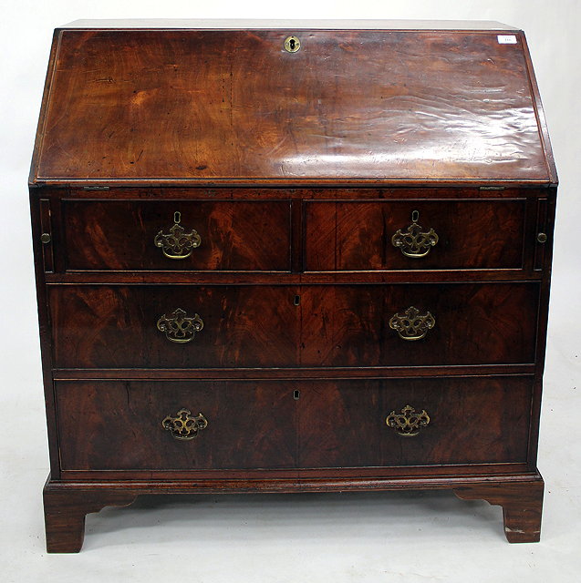 Appraisal: A GEORGE III MAHOGANY BUREAU with a fall front enclosing