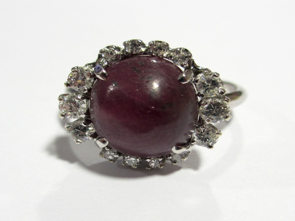 Appraisal: A ct white gold cabochon ruby and diamond cluster ring