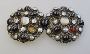 Appraisal: Large pierced cast buckle set cabochon garnet and mother-of-pearl