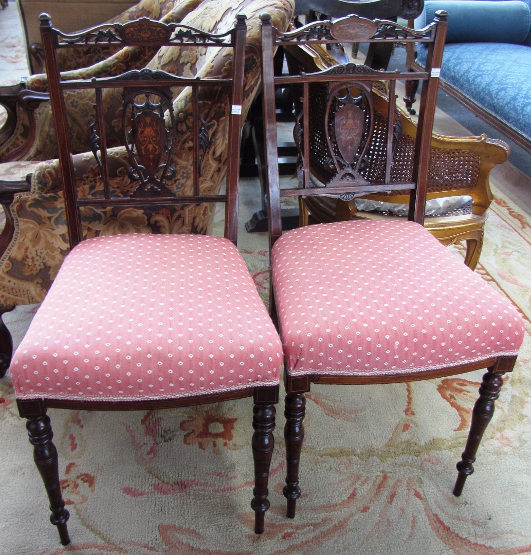 Appraisal: A pair of marquetry inlaid rosewood bedroom chairs with bow