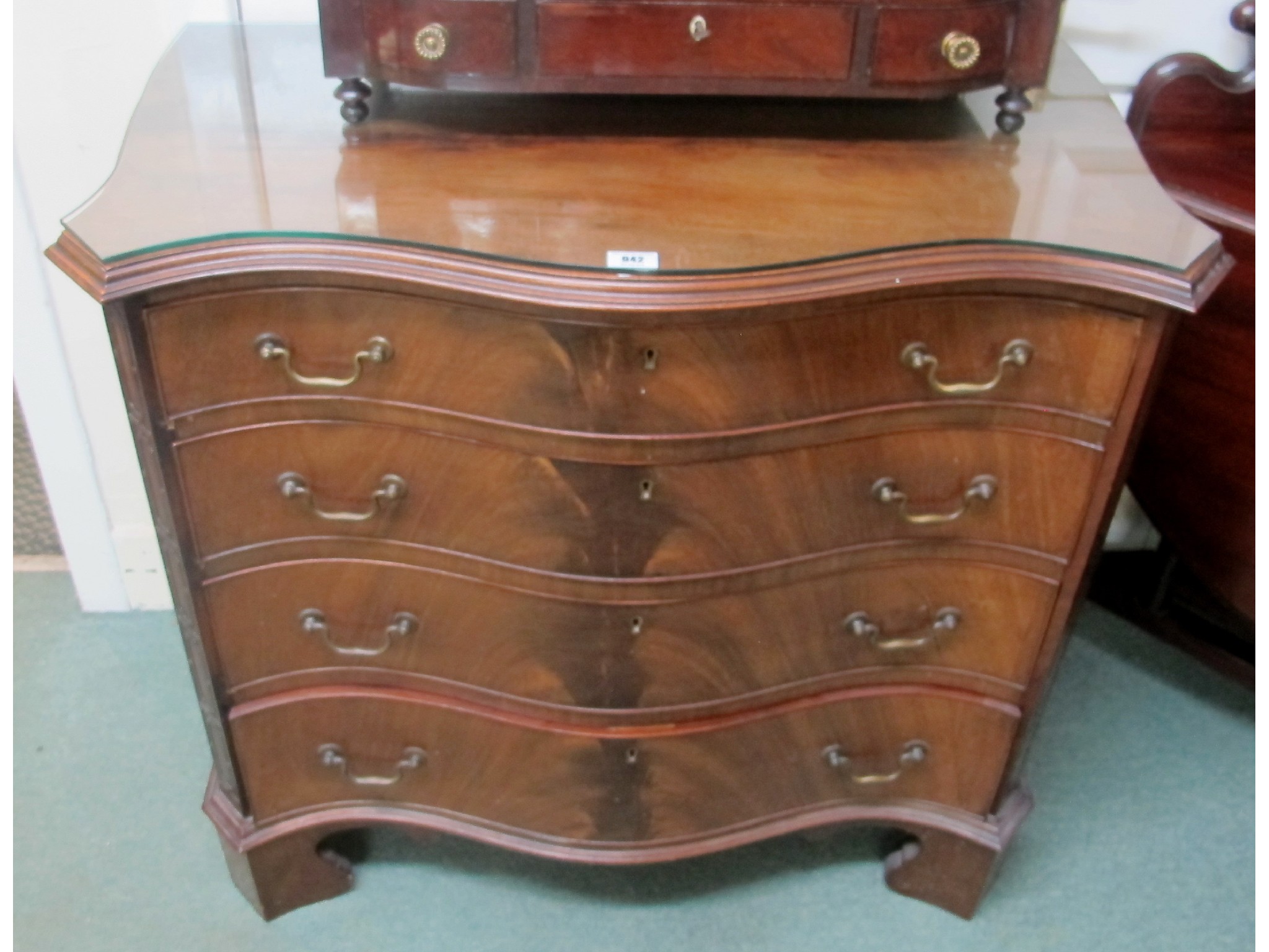 Appraisal: Mahogany serpentine front four drawer chest