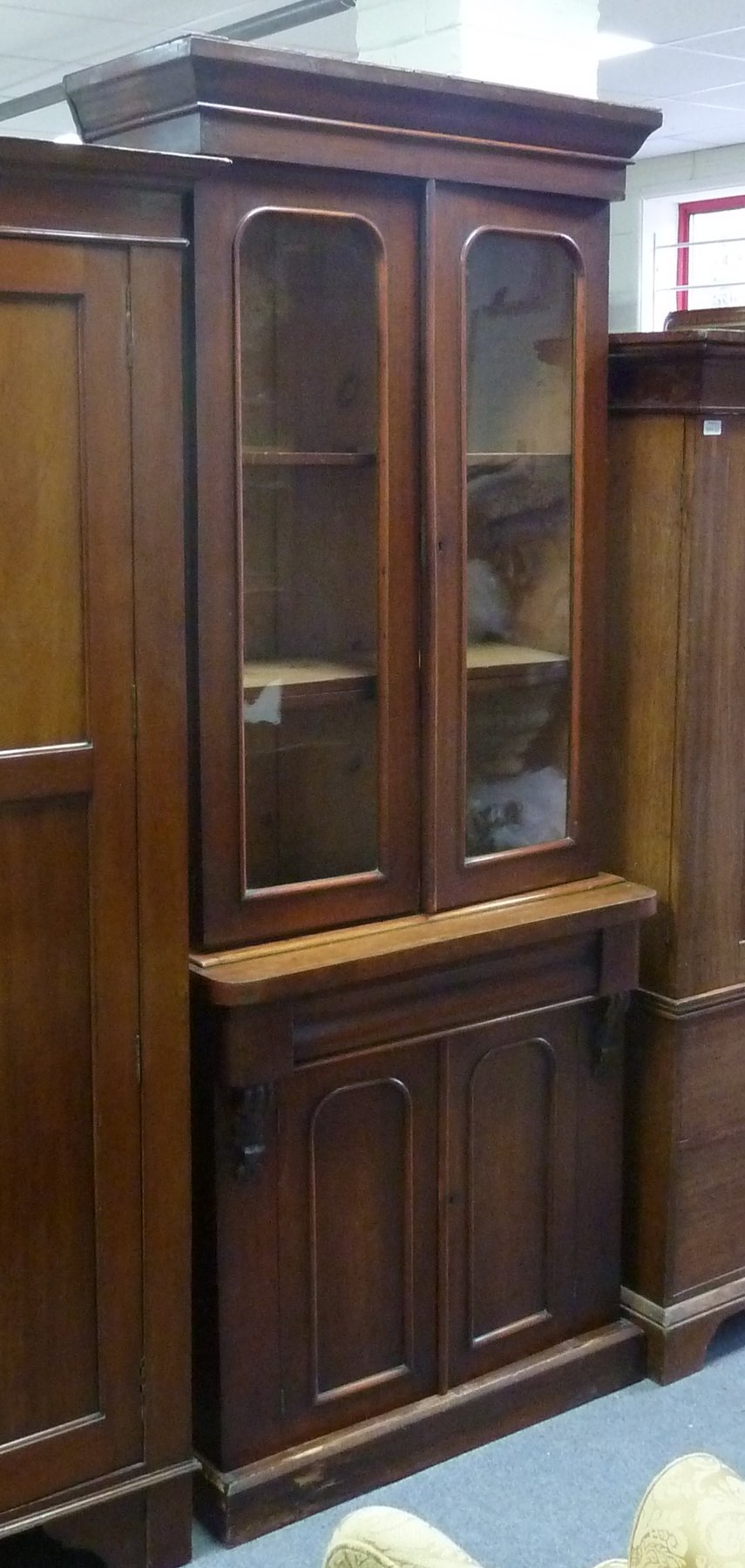 Appraisal: A mahogany Victorian bookcase with glazed cupboards above panelled cupboards