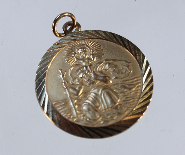 Appraisal: A St Christopher pendant with a circular body with outer