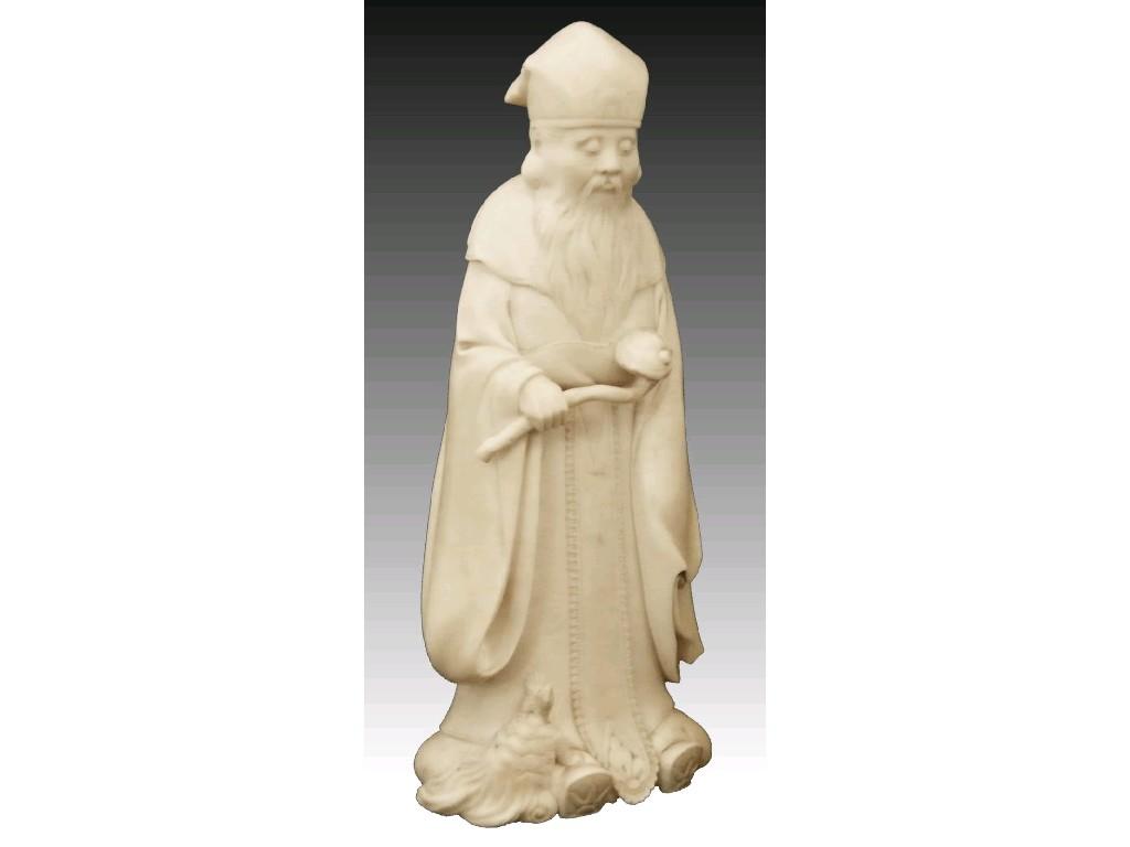 Appraisal: Japanese ivory okimono of a bearded priest modelled with a