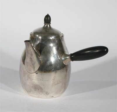 Appraisal: A Georg Jensen silver coffee pot and cover with ebonised