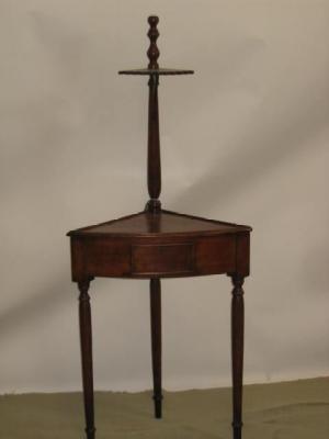 Appraisal: A MAHOGANY CORNER TABLE of bowed form surmounted by a