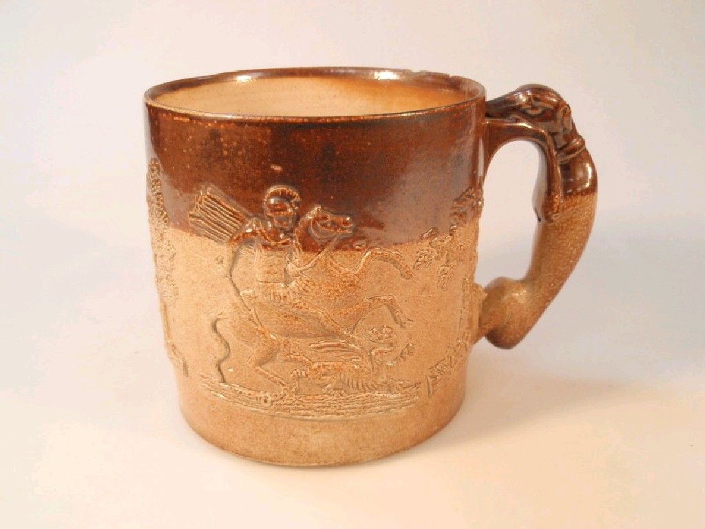 Appraisal: A thC buff glaze pottery mug moulded in relief with