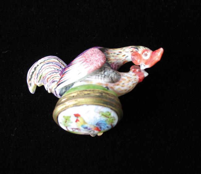 Appraisal: A CONTINENTAL ENAMEL PATCHBOX modelled as a cockerel and a