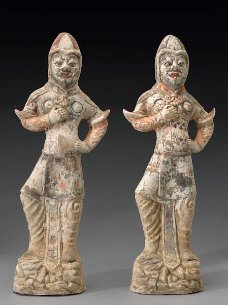 Appraisal: A pair of painted pottery guardian figures Tang Dynasty Each