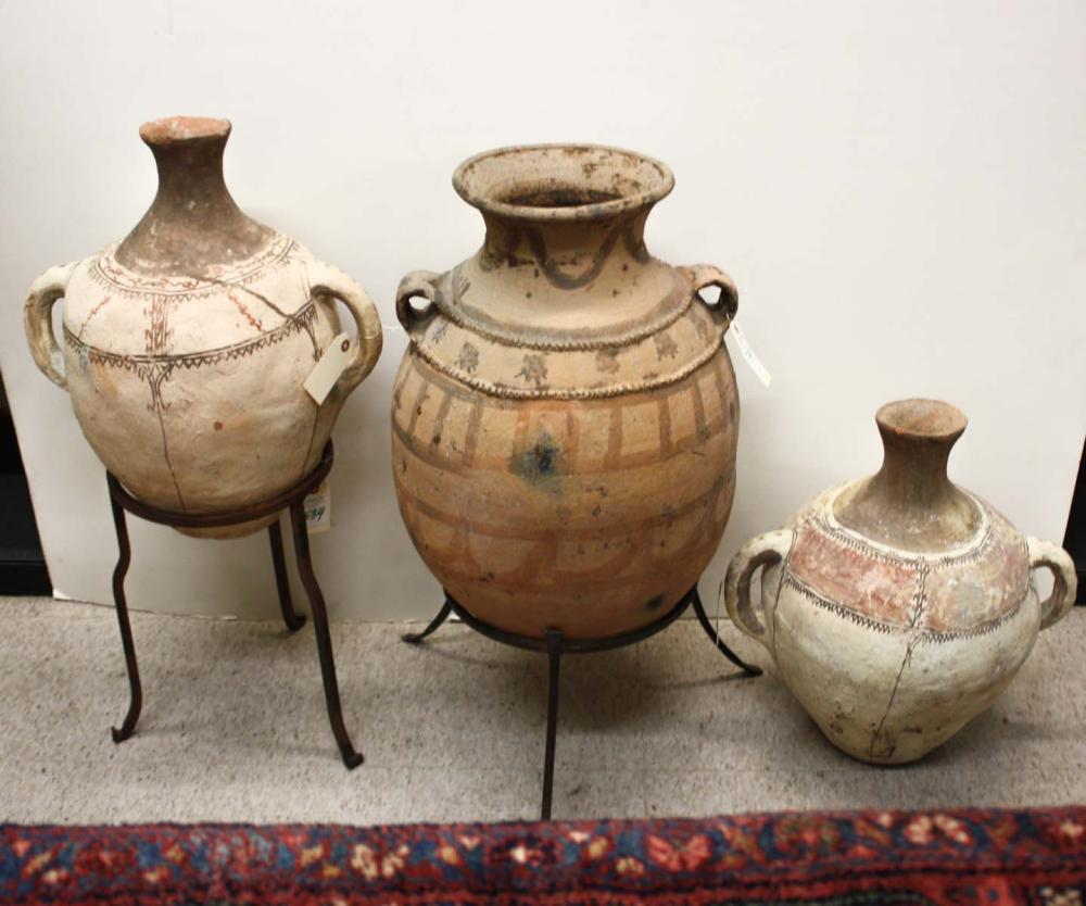 Appraisal: THREE PAINT-DECORATED TERRACOTTA JARS two displayed on custom wrought iron