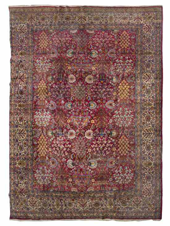 Appraisal: A Sarouk Wool Rug having allover foliate decoration on a