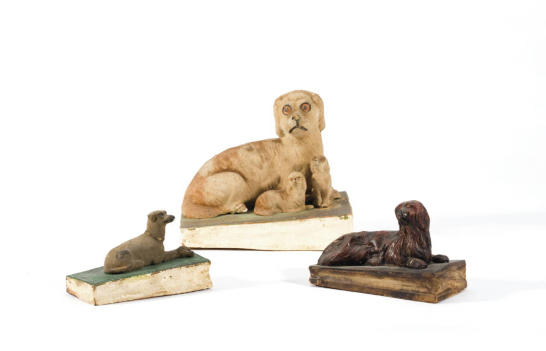 Appraisal: THREE PAINTED OR FELT-COVERED PAPIER MACHE WOOD AND LEATHER DOG