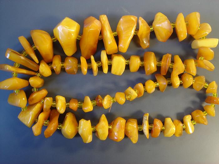 Appraisal: Amber Beaded Necklace Graduated strand with glass beads between Estimate