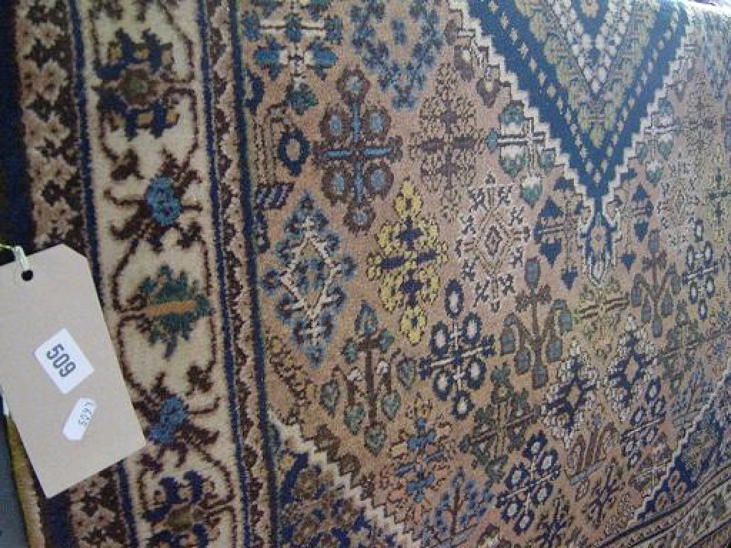 Appraisal: An Eastern wool carpet with stylised floral motifs in blue