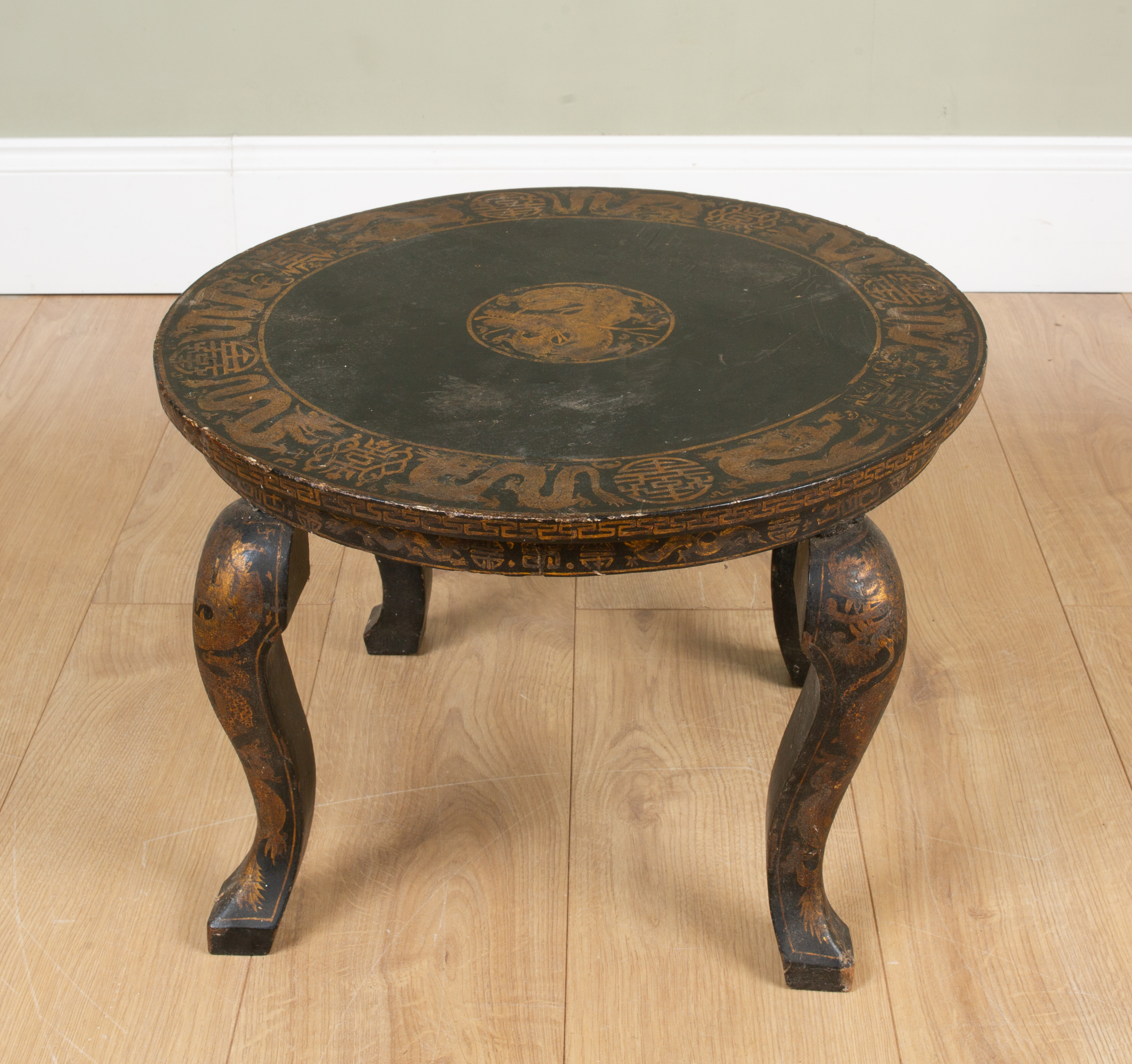 Appraisal: A circular low chinoiserie style black lacquered occasional table with