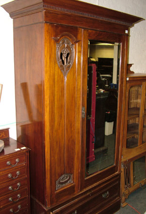 Appraisal: An Art Nouveau style mahogany wardrobe the dentil moulded cornice