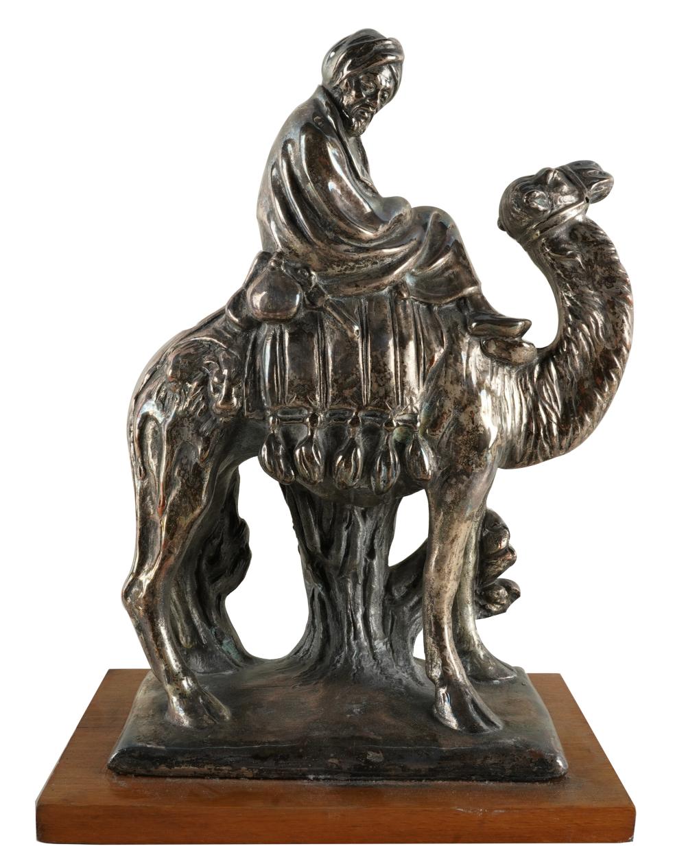 Appraisal: SILVERED METAL FIGURE OF A CAMEL RIDERsigned and dated illegible