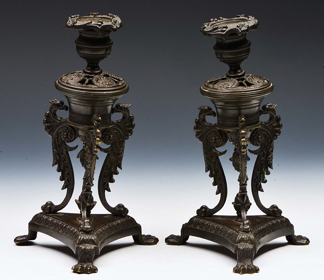 Appraisal: A PAIR OF REGENCY BRONZE CANDLESTICKS of classical mythological creature