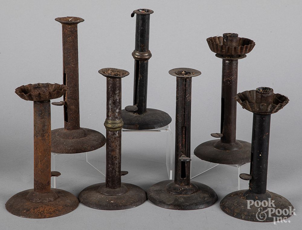 Appraisal: Seven hogscraper candlesticks th c Seven hogscraper candlesticks th c