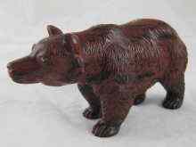 Appraisal: A carved hardstone Russian bear brown with black striations length