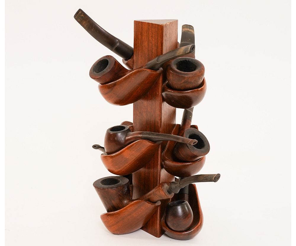 Appraisal: Nine Pipes in Carved Pipe Stand Carved wood pipe stand